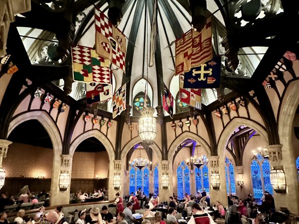 banquet hall inside cinderella's royal table. beautiful royal flags surround the ceiling
