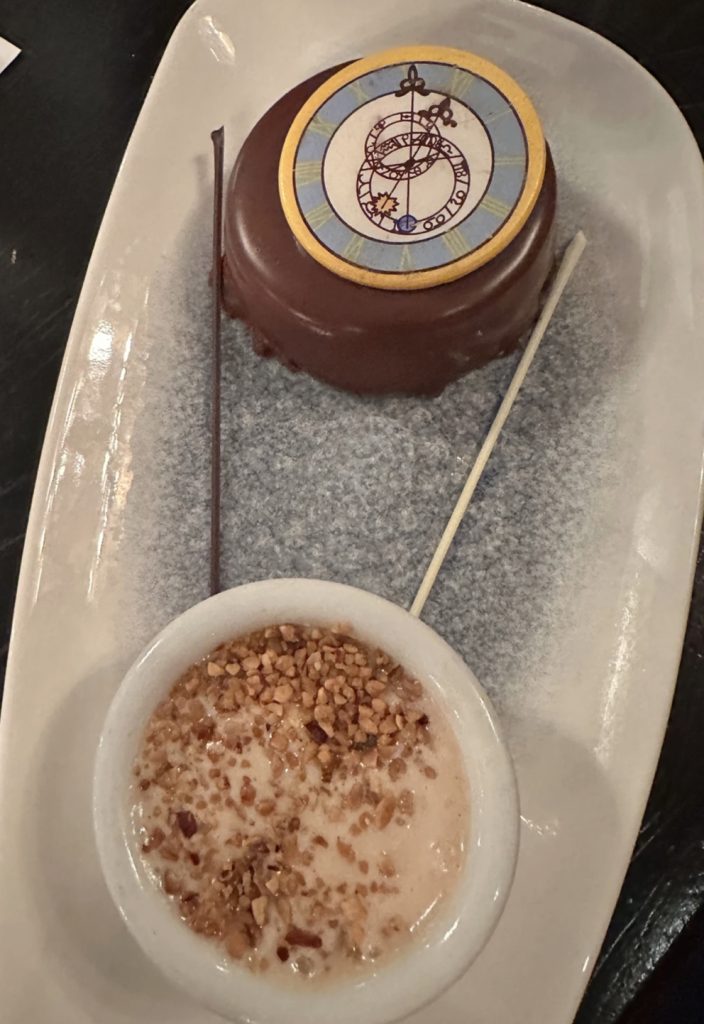 decorated chocolate mousse with a chocolate clock coin on top