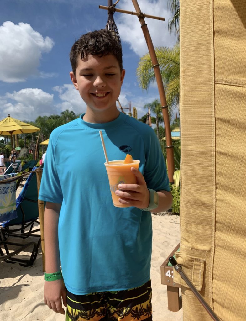 boy with frozen drink at volcano bay