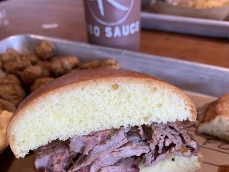 half of a brisket sandwich full of meat