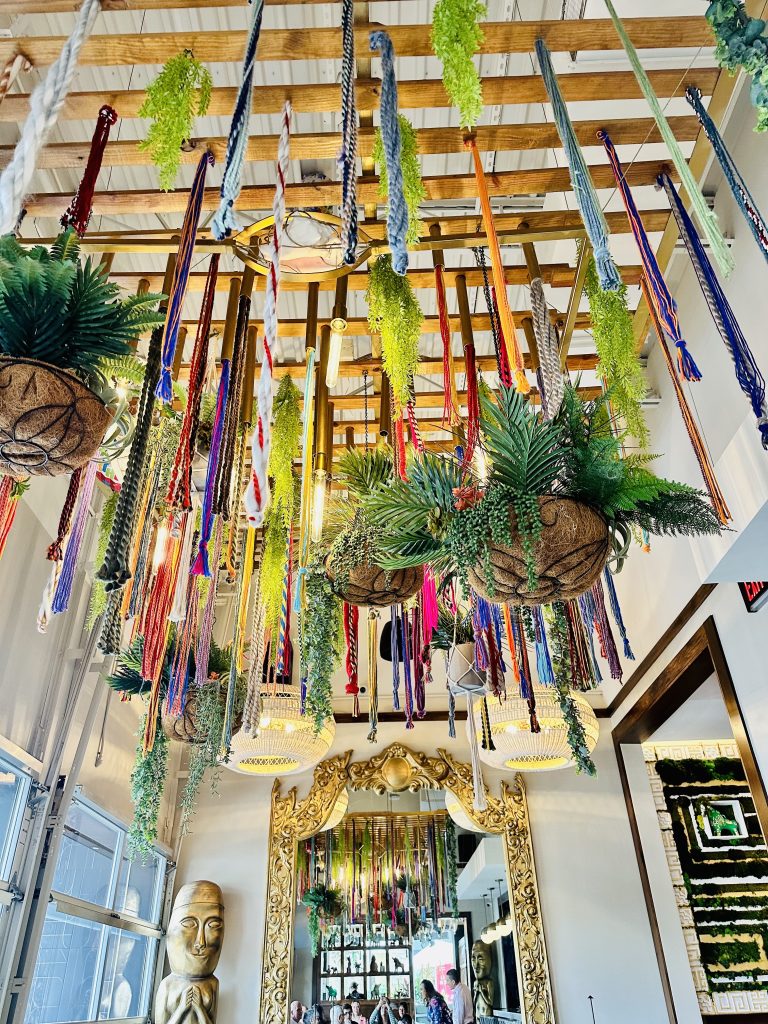 colorful hanging yarn and planters hanging from pisco Peruvian gastrobar ceiling