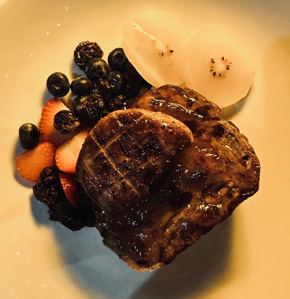 foie gras on a fruit bread with berries on the side at Bites & Bubbles Orlando