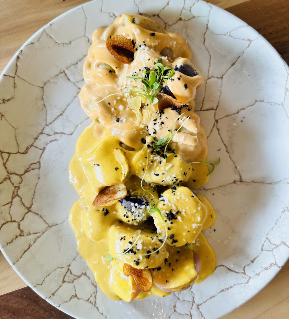 diced potatoes covered in a yellow sauce