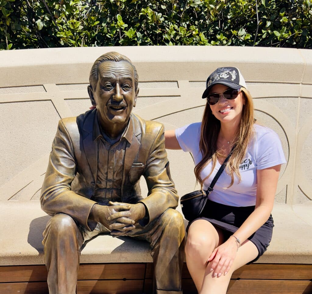 autumn from Flamingo in Fantasyland with a Walt disney statue at epcot