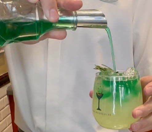 making lobe blaster cocktail at bar moonshine in epic universe